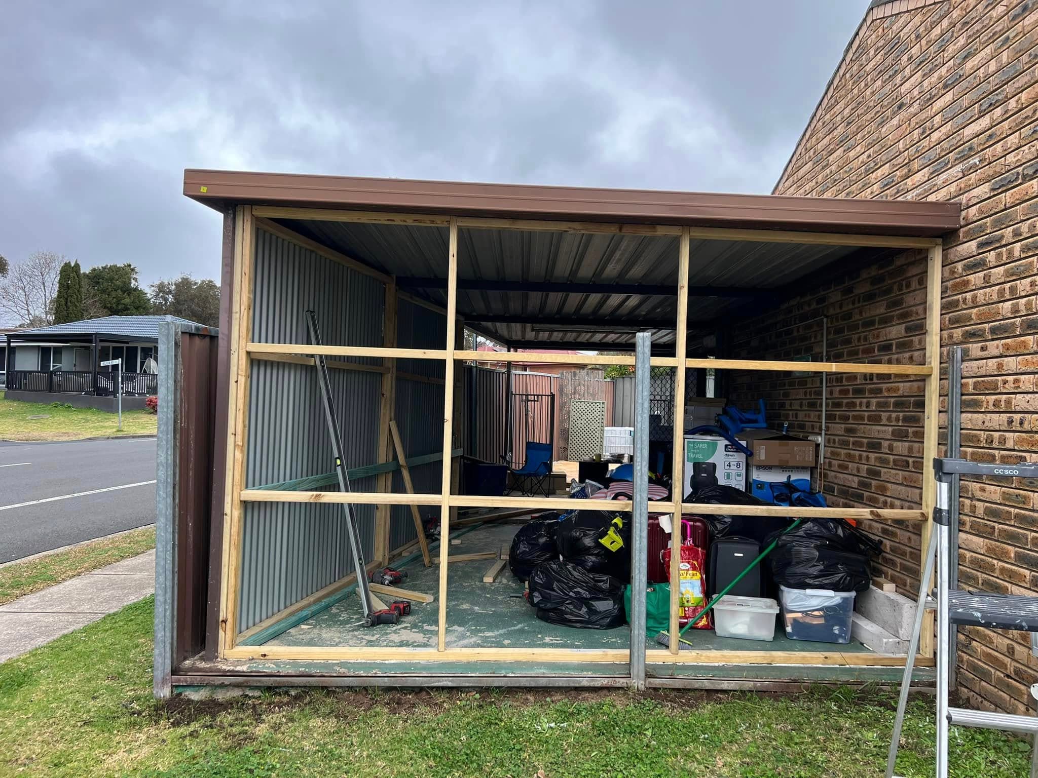 Timber framing enclosing a carport opening