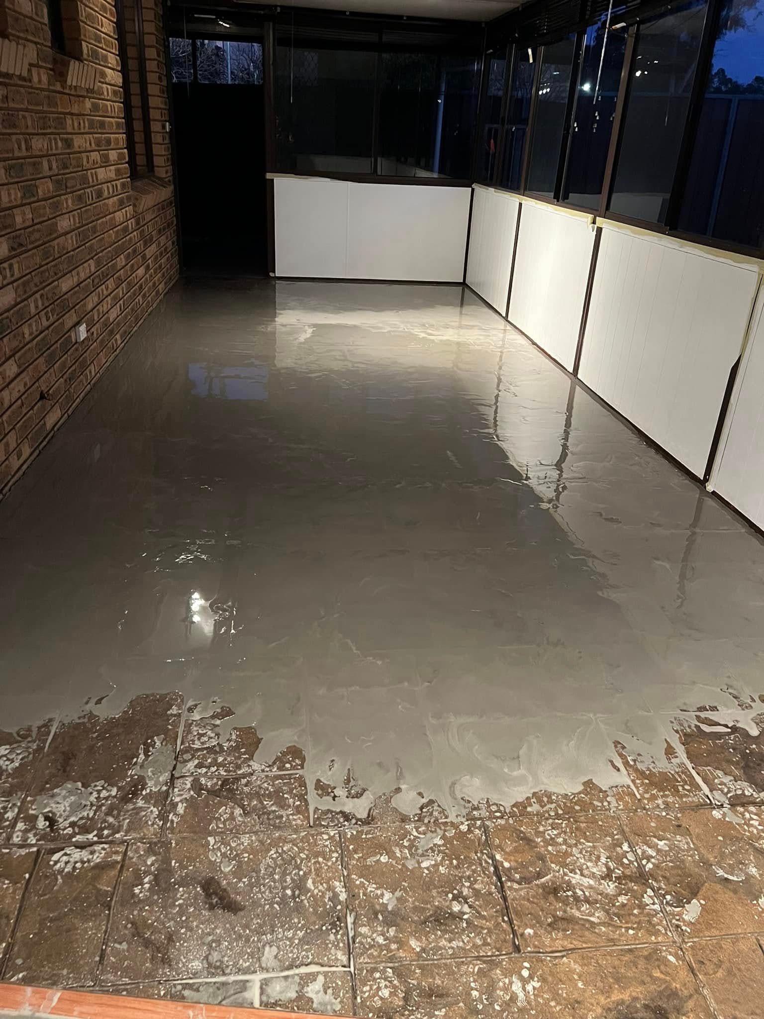 Self-levelling compound poured over an old patio floor
