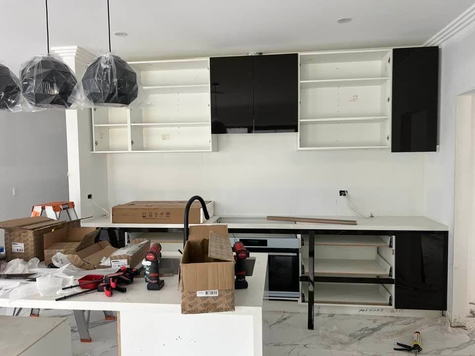 Black gloss kitchen cabinets part-installed