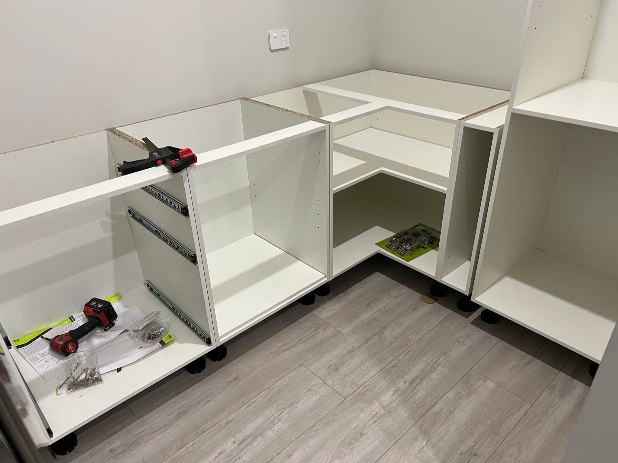 Kitchen base cabinets being installed