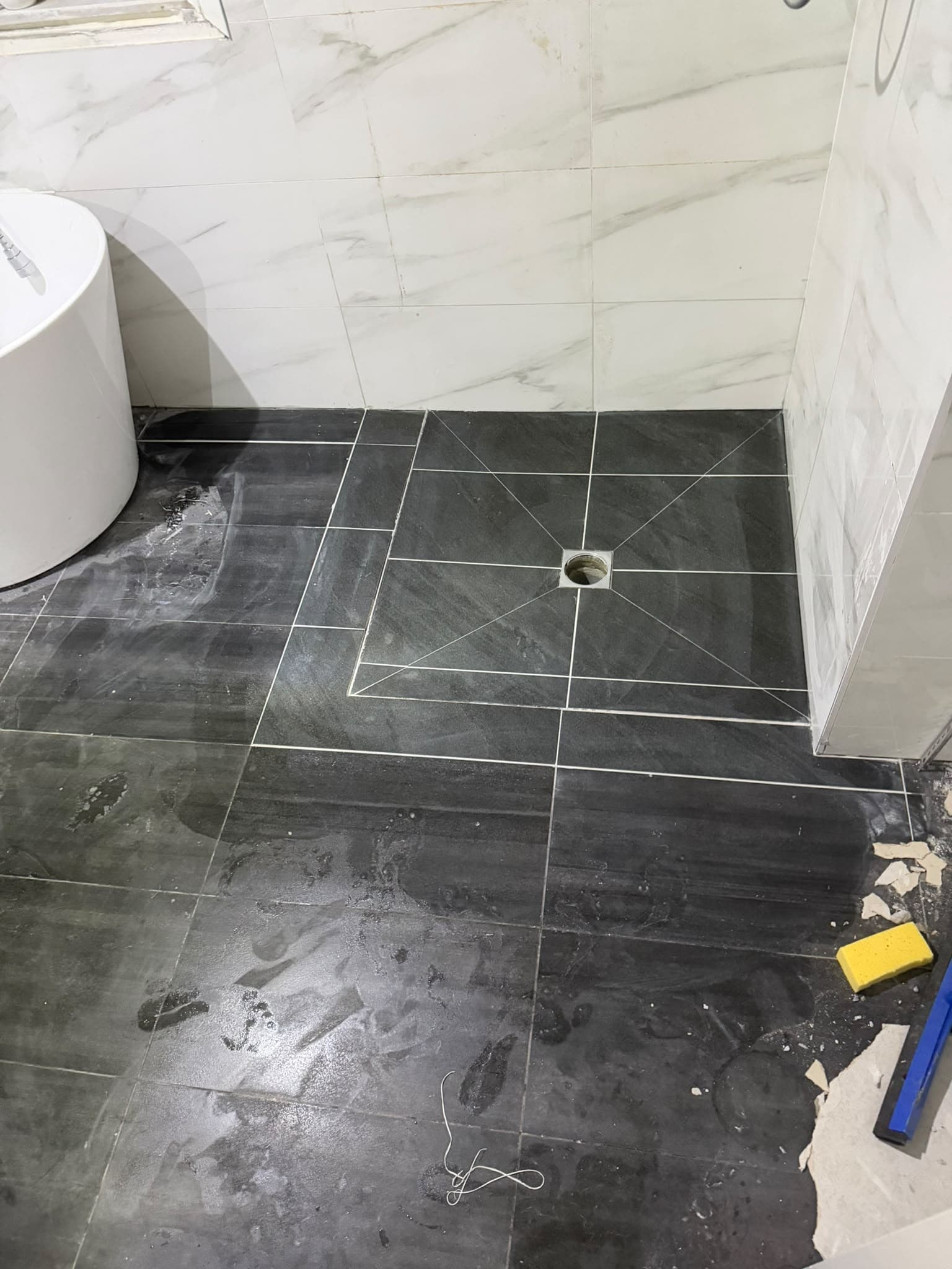 Bathroom floor tiled to fall towards the drain
