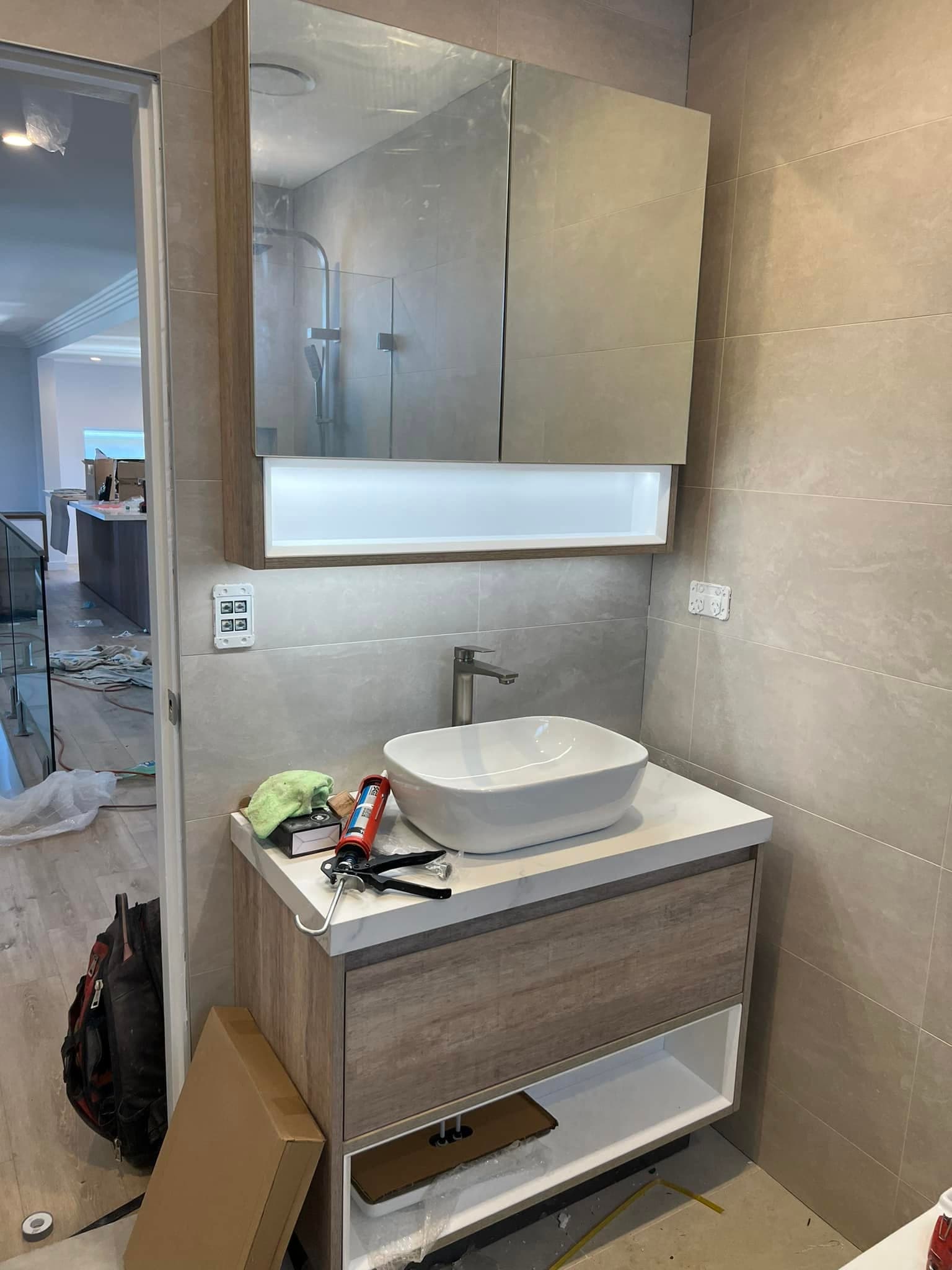 Bathroom vanity and mirrored cabinet installed