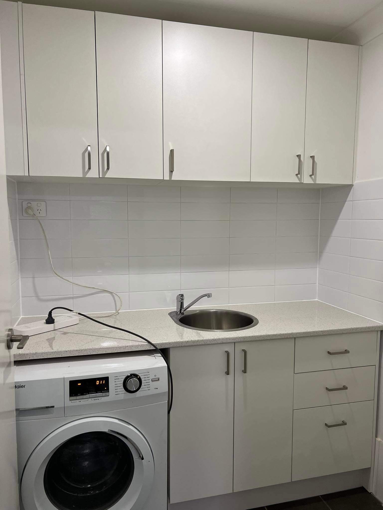 Finished laundry with a stone benchtop